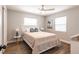 Cozy bedroom featuring wood floors, white trim, ceiling fan and bright natural light at 6009 Lords Ave, Sarasota, FL 34231