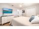 Bedroom features a flat screen television, white trim and a view to bathroom at 6009 Lords Ave, Sarasota, FL 34231