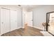 Bedroom with a double closet, neutral walls, and wood flooring, offering a peaceful retreat at 6009 Lords Ave, Sarasota, FL 34231