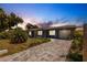 Charming single-story home with a well-manicured lawn and brick driveway at 6009 Lords Ave, Sarasota, FL 34231