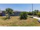 Well-maintained front yard with tropical landscaping enhancing the curb appeal at 6009 Lords Ave, Sarasota, FL 34231