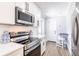 Modern kitchen with stainless steel appliances, quartz countertops, and eat-in bar at 6009 Lords Ave, Sarasota, FL 34231