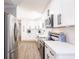 Modern kitchen with white cabinets, stainless appliances, and wood-style floors for a sleek design at 6009 Lords Ave, Sarasota, FL 34231