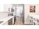 Updated kitchen featuring white cabinets, stainless steel appliances, and breakfast table with seating at 6009 Lords Ave, Sarasota, FL 34231