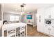 Open-concept living and kitchen area with modern design and a breakfast table set at 6009 Lords Ave, Sarasota, FL 34231