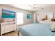 Bright main bedroom featuring a ceiling fan, a flat screen tv and beach themed decor at 6009 Lords Ave, Sarasota, FL 34231