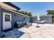 Private paved patio with modern outdoor seating, umbrella, and a comfortable hammock for relaxation at 6009 Lords Ave, Sarasota, FL 34231