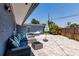 Cozy patio with cushioned sofa, coffee table, umbrella, and a hammock, ideal for outdoor relaxation at 6009 Lords Ave, Sarasota, FL 34231