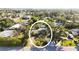 Aerial view of the home surrounded by mature trees and located in a quiet neighborhood at 610 Poinsettia Rd, Nokomis, FL 34275
