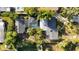 Aerial view of property featuring a screened-in pool, lush greenery, and a well-maintained roof at 610 Poinsettia Rd, Nokomis, FL 34275