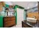 Stylish bathroom featuring green walls, unique baskets and decorative touches, and a sleek vessel sink at 610 Poinsettia Rd, Nokomis, FL 34275