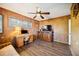 Wood-paneled bedroom with a ceiling fan, desk, and media center, creating a functional living area at 610 Poinsettia Rd, Nokomis, FL 34275