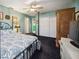 Spacious bedroom featuring blue walls, ceiling fan, and dark carpet providing a relaxing atmosphere at 610 Poinsettia Rd, Nokomis, FL 34275