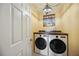 Modern laundry room featuring front-loading washer and dryer at 610 Poinsettia Rd, Nokomis, FL 34275