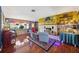 Living room with stone fireplace, hardwood floors, and unique wall decorations at 610 Poinsettia Rd, Nokomis, FL 34275
