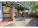 Outdoor shower and workspace with gravel floor and wood enclosure at 610 Poinsettia Rd, Nokomis, FL 34275