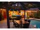 Poolside patio with ample seating, dining area, and bar, ideal for evening entertaining at 610 Poinsettia Rd, Nokomis, FL 34275
