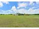 Large backyard featuring lush green grass, mature trees, a pool, and an outdoor lounge area at 6316 Foxbrook Trl, Parrish, FL 34219