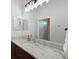 Bathroom with a granite countertop vanity, decorative lighting, and towel hangers at 6316 Foxbrook Trl, Parrish, FL 34219
