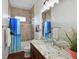 Bathroom featuring granite countertop vanity, wood floors, and tub with shower at 6316 Foxbrook Trl, Parrish, FL 34219