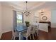 Dining room with traditional furniture, large window and modern light fixture at 6316 Foxbrook Trl, Parrish, FL 34219