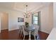 Bright dining room featuring a modern chandelier and hardwood floors at 6316 Foxbrook Trl, Parrish, FL 34219