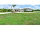 Elegant home with lush landscaping, circular driveway, and a well-maintained lawn at 6316 Foxbrook Trl, Parrish, FL 34219