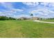 Expansive front lawn leading up to this bright single-story home with a circular driveway at 6316 Foxbrook Trl, Parrish, FL 34219