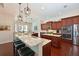 Kitchen featuring granite counters, stainless appliances, and seating area at 6316 Foxbrook Trl, Parrish, FL 34219