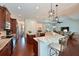 Gourmet kitchen with a large island, granite countertops, stainless appliances and view to living room at 6316 Foxbrook Trl, Parrish, FL 34219