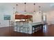 Eat-in kitchen with granite countertops, two islands, stainless appliances and pendant lighting at 6316 Foxbrook Trl, Parrish, FL 34219