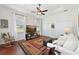 Living room with wood floors, ceiling fan, large window and comfortable sofa at 6316 Foxbrook Trl, Parrish, FL 34219