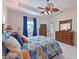 Bright main bedroom boasts a decorative ceiling fan, patio access, and wood furniture at 6316 Foxbrook Trl, Parrish, FL 34219