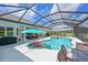 Inviting screened-in pool with a spa, ample deck space, and outdoor seating areas at 6316 Foxbrook Trl, Parrish, FL 34219