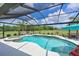 Screened pool with an attached spa and a lovely view of the golf course beyond the manicured lawn at 6316 Foxbrook Trl, Parrish, FL 34219
