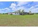 Beautiful backyard with a screened lanai, mature landscaping and a large, lush lawn at 6316 Foxbrook Trl, Parrish, FL 34219