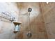 Shower with tiled walls, shelving, and an adjustable shower head at 6316 Foxbrook Trl, Parrish, FL 34219