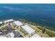 Aerial view of bayfront condominiums, green space, parking area, and waterfront at 6400 Flotilla Dr # 87, Holmes Beach, FL 34217