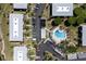 An aerial view showcasing the community pool, parking, and multiple residential buildings in a landscaped setting at 6400 Flotilla Dr # 87, Holmes Beach, FL 34217
