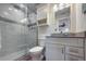 Bathroom showcasing vanity with solid countertops, tiled shower with glass door, and tiled flooring at 6400 Flotilla Dr # 87, Holmes Beach, FL 34217