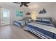 Coastal style bedroom featuring two beds, striped bedding, and sliding glass doors to the outside at 6400 Flotilla Dr # 87, Holmes Beach, FL 34217