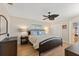 Cozy bedroom features a comfortable bed, nautical decor, ceiling fan, and ample natural light at 6400 Flotilla Dr # 87, Holmes Beach, FL 34217