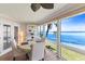 Waterfront dining area with panoramic views, white table and chairs, and ample natural light at 6400 Flotilla Dr # 87, Holmes Beach, FL 34217