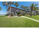 Charming two-story condo with palm trees, green grass, and beautiful water view in a tropical setting at 6400 Flotilla Dr # 87, Holmes Beach, FL 34217