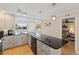 Bright kitchen featuring a breakfast bar, stainless steel appliances, and access to the dining room and bedroom at 6400 Flotilla Dr # 87, Holmes Beach, FL 34217