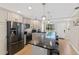 Modern kitchen features stainless appliances, gray cabinets, bar seating, and lots of natural light at 6400 Flotilla Dr # 87, Holmes Beach, FL 34217
