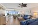 Cozy living room featuring a ceiling fan, comfortable seating, wood flooring, and sliding glass doors to a water view at 6400 Flotilla Dr # 87, Holmes Beach, FL 34217