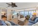 Bright living room boasts ocean views and coastal decor with tropical furnishings and a ceiling fan at 6400 Flotilla Dr # 87, Holmes Beach, FL 34217