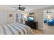 Serene main bedroom offers private balcony, ceiling fan, and easy access to the ensuite bathroom at 6400 Flotilla Dr # 87, Holmes Beach, FL 34217