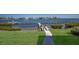 Private wooden pier offers direct water access for boating and enjoying the serene waterfront views at 6400 Flotilla Dr # 87, Holmes Beach, FL 34217